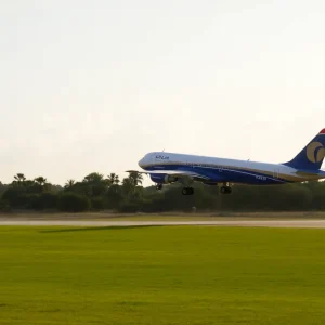 Airplane taking off against a sunny Florida backdrop.